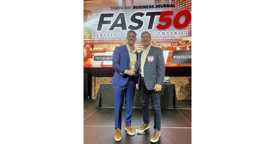 Justin and David Caballero holding the Tampa Bay Business Journal Fast 50 cover